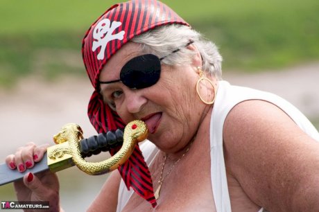 Fat British granny exposes herself on a bridge while sporting pirate attire
