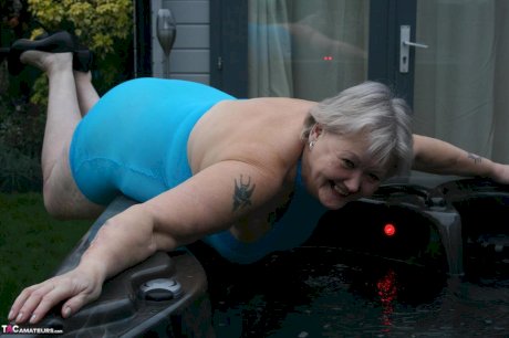 Fat granny hikes up see thru dress to expose her vagina in black pumps