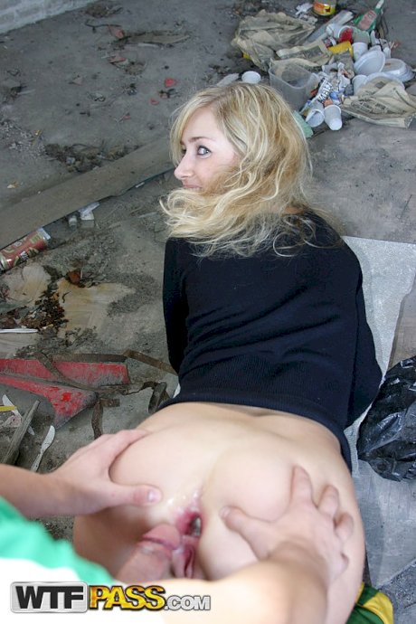 Blonde girl does hardcore anal in an abandoned building with strangers