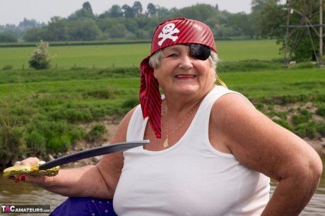 Fat British granny exposes herself on a bridge while sporting pirate attire