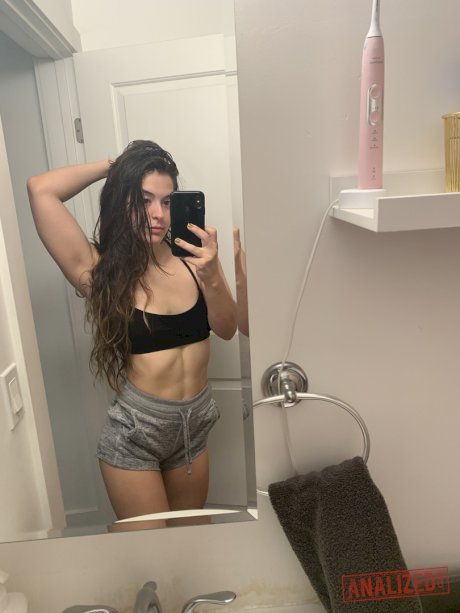 Brunette amateur takes selfies while getting naked in front of a mirror