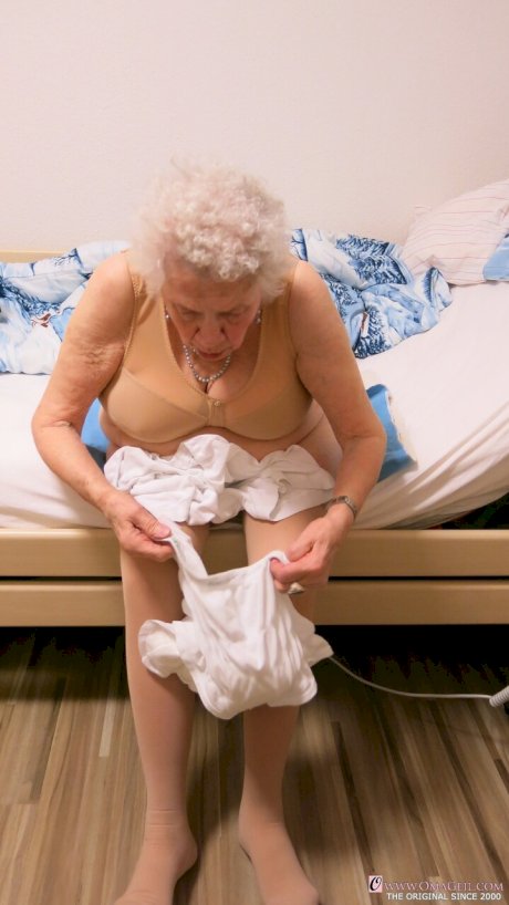 Kinky old granny Ornella poses naked and teases with her huge juggs