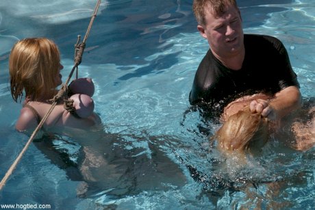 Thick redhead is hogtied in a swimming pool before being freed - Photo 12