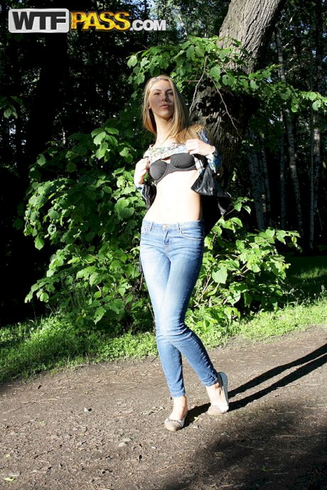 Slim amateur uncovers her small tits in blue jeans during homemade action