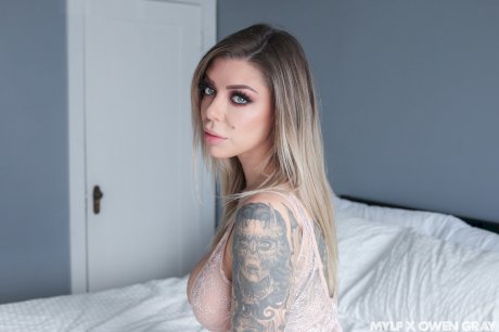 Tattooed MILF with grand boobs Karma RX rides a fat hard cock on a bed