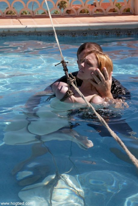 Thick redhead is hogtied in a swimming pool before being freed - Photo 17