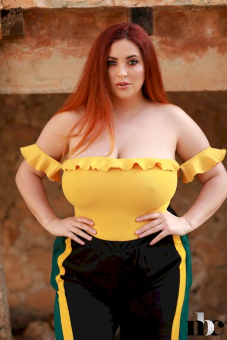 Redheaded fatty Lucy Vixen strips outdoors and shows off her big boobs