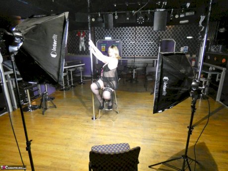 Older amateur Posh Sophia works a stripper pole inside an empty club