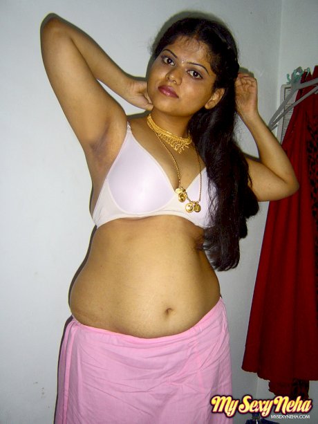 Plump Indian girl Neha gets totally naked on her bed in solo action