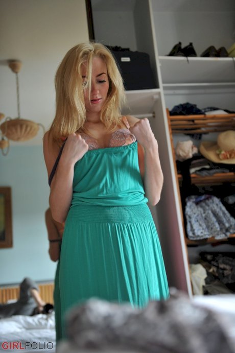 Blonde girl Sophia Smith tries on various items of lingerie in her bedroom