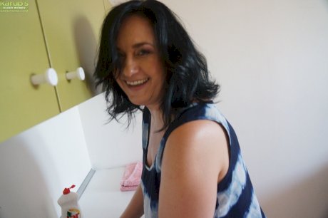 Older housewife Ria Black strips after washing up dishes to finger her pussy