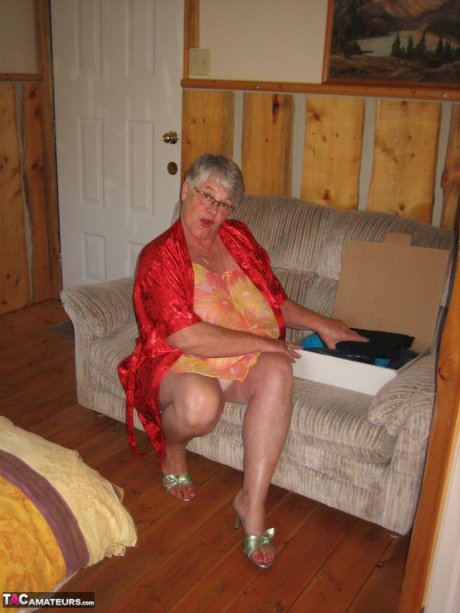 Obese granny Girdle Goddess wakes up from a nap and precedes to strip naked