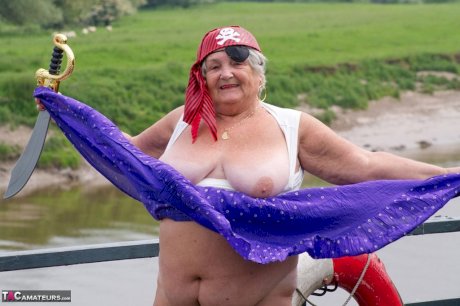 Fat British granny exposes herself on a bridge while sporting pirate attire