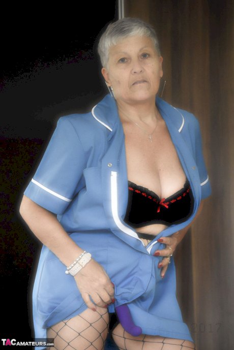 Old woman with short hair and floppy tits dons a strapon in fishnet pantyhose