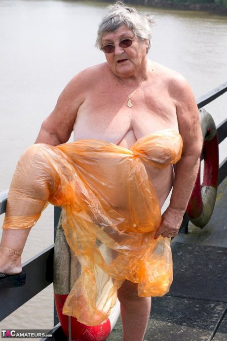 Obese oma Grandma Libby doffs a see-through raincoat to get naked on a bridge