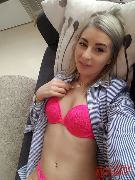 Amateur blonde Ari Fox reveals her small boobs and poses in front of a camera