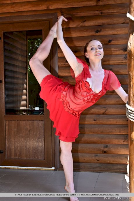 Flexible girl Stacy Redi gets completely naked while out on a balcony