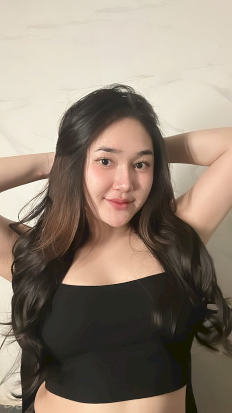 Petite Asian teen Lotus Huahang flaunts her big bum and natural tits