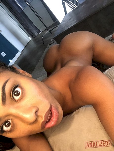 Ebony girl Kira Noir teases with her small bum and tiny tits in a solo