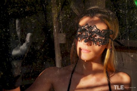 Sexy teen Stefany takes off a masquerade mask in a revealing bodystocking