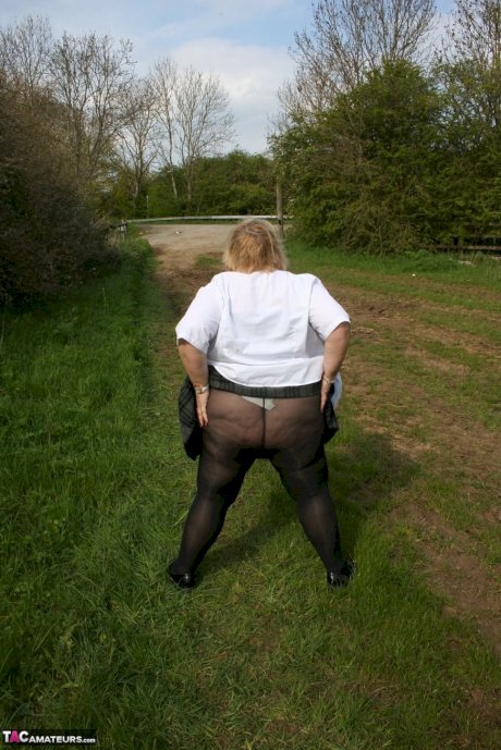 Thick British woman Lexie Cummings exposes herself in a field while wearing hose - Photo 14