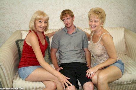 Two blonde grannies share a horny student's hard white dick on the sofa