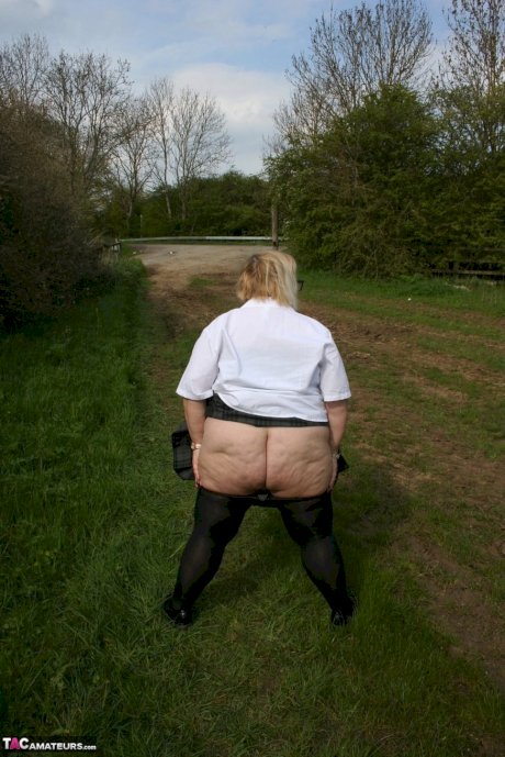 Thick British woman Lexie Cummings exposes herself in a field while wearing hose - Photo 15