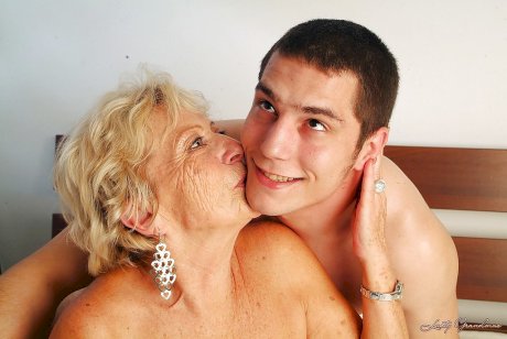 Lustful granny with massive jugs gets her hairy cunt pleased by a younger lad