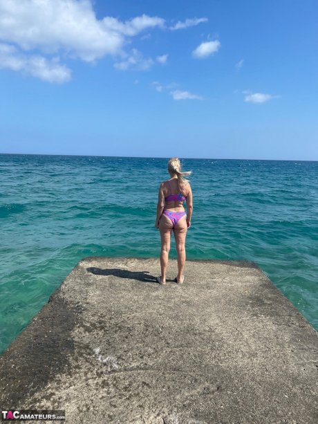 Middle-aged blonde Sweet Susi releases her natural tits and twat from a bikini