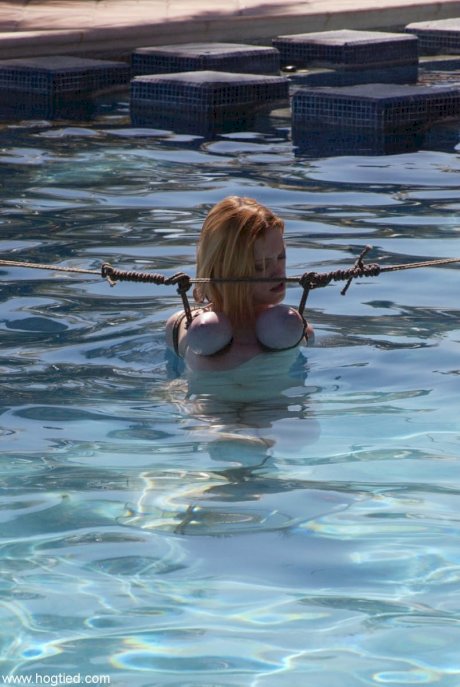 Thick redhead is hogtied in a swimming pool before being freed - Photo 7