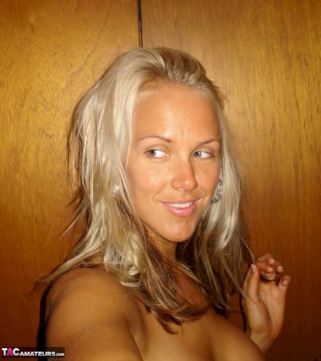 Hot blonde Aussie Jewel displays her big boobs while taking nude selfies