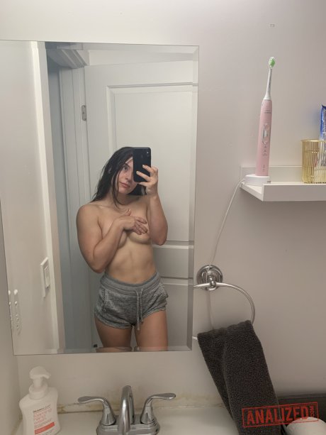 Brunette amateur takes selfies while getting naked in front of a mirror