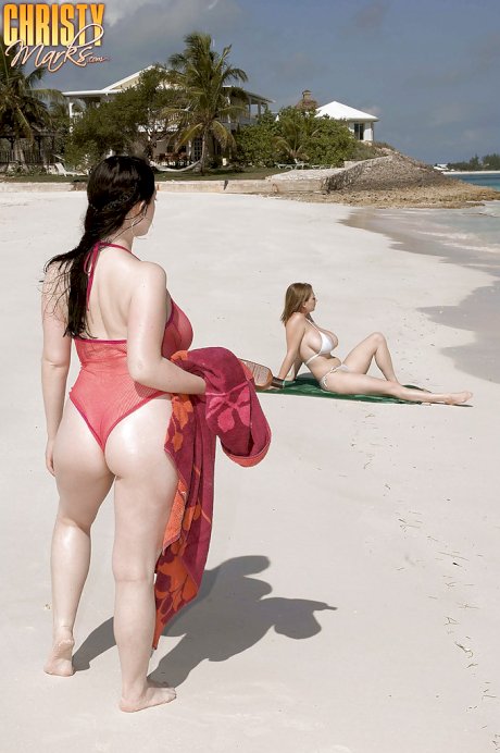 Fervent lesbians stripping nude and playing with dildos on the beach