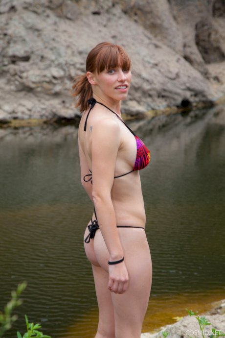 Hot redhead amateur disrobes at the lake to go skinny dipping & sunbathe nude