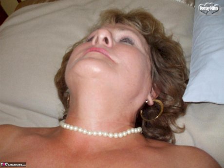 Older amateur Busty Bliss displays her tanned lined boobs in pantyhose