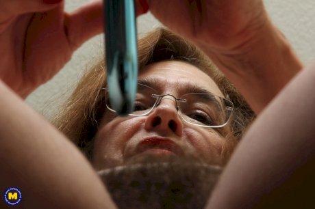 Mature American female pleasures her hairy bush with a vibrator