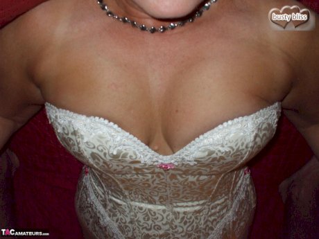 Older amateur Busty Bliss releases her big natural tits from a laced corset