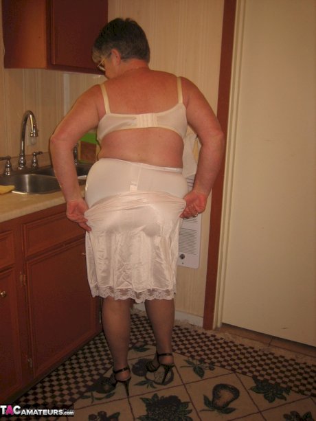 Old woman Girdle Goddess strips to pantyhose in her kitchen