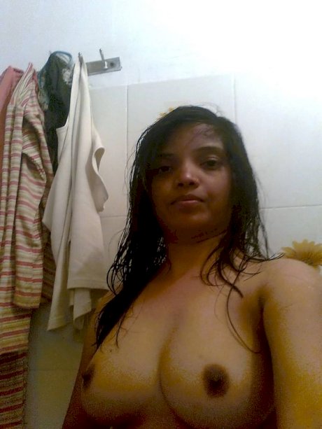 Indian female exposes her big natural tits during candid action at home