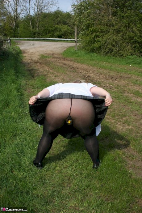 Thick British woman Lexie Cummings exposes herself in a field while wearing hose - Photo 11