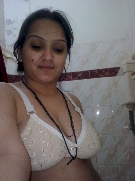 Overweight Indian student shows her bare mid-section in a brassiere
