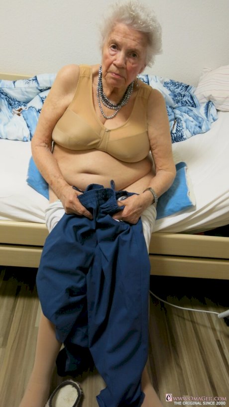Kinky old granny Ornella poses naked and teases with her huge juggs