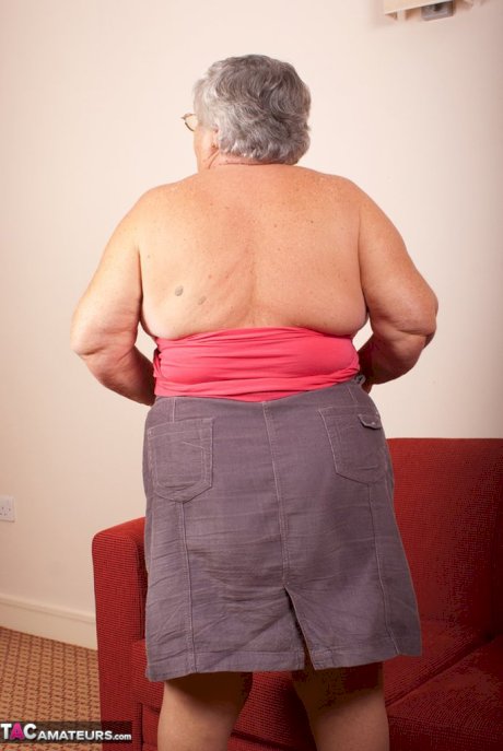 Obese nan Grandma Libby gets totally naked on a red chesterfield