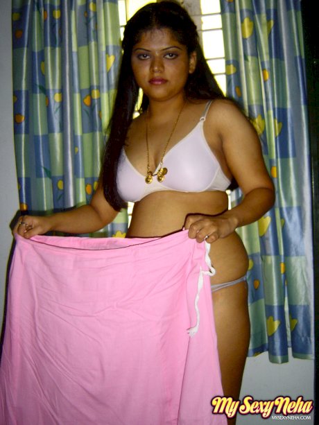 Plump Indian girl Neha gets totally naked on her bed in solo action