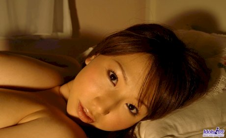 Japanese beauty Ai Sayama grabs a full breast while posing in her bedroom