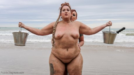 Slutty BBW Mimosa eats pussy while buried up to her neck in a kinky BDSM scene