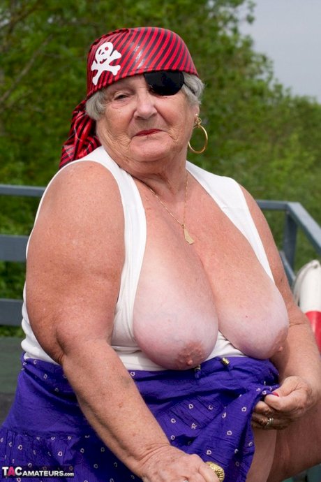 Fat British granny exposes herself on a bridge while sporting pirate attire