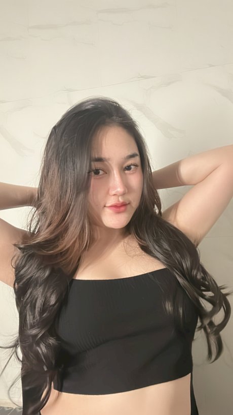 Petite Asian teen Lotus Huahang flaunts her big bum and natural tits