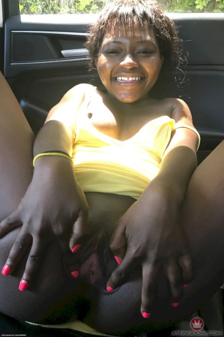 Petite ebony Noemie Bilas exposing her tits, pussy and feet in a solo