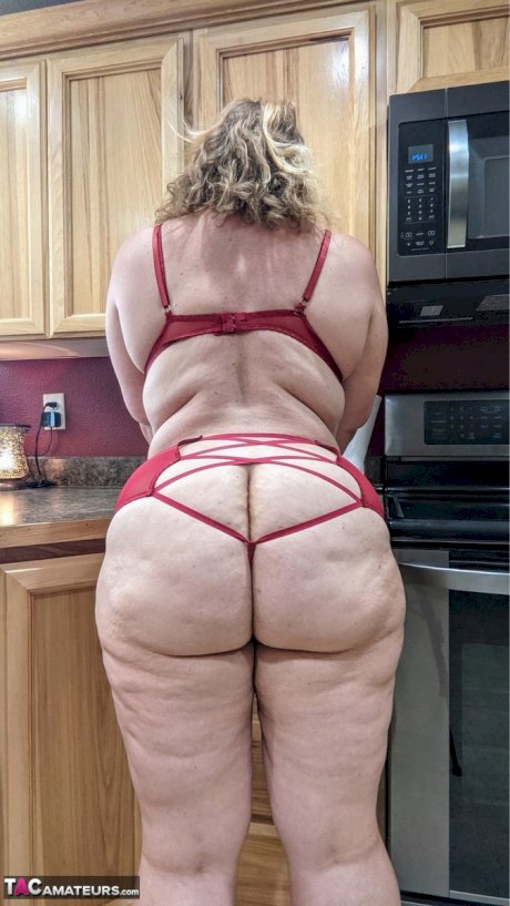 Amateur woman Busty Kris Ann shows her big tits and butt in her kitchen